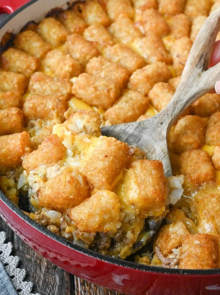 Delicious Big Mac Casserole topped with cheese and garnished with lettuce and pickles.