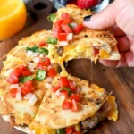 Breakfast quesadillas filled with eggs, cheese, and vegetables on a plate