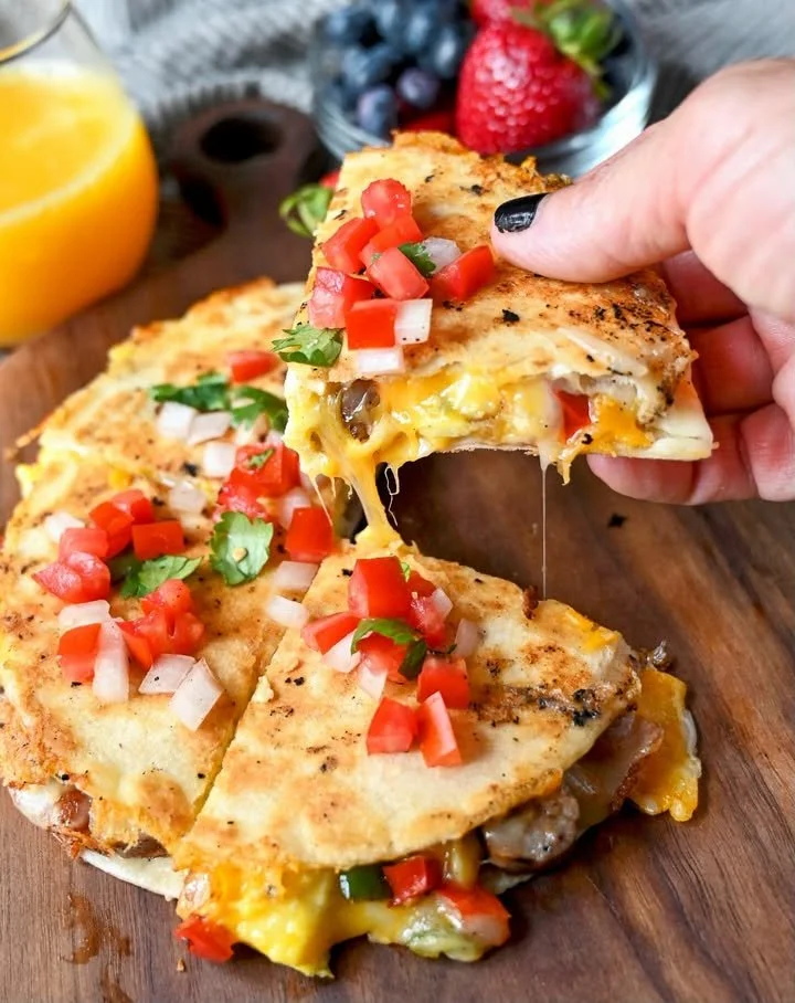 Breakfast Quesadillas Breakfast quesadillas filled with eggs, cheese, and vegetables on a plate