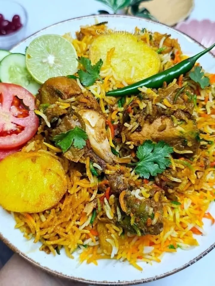 Delicious Chicken Biryani garnished with herbs and served in a traditional bowl.
