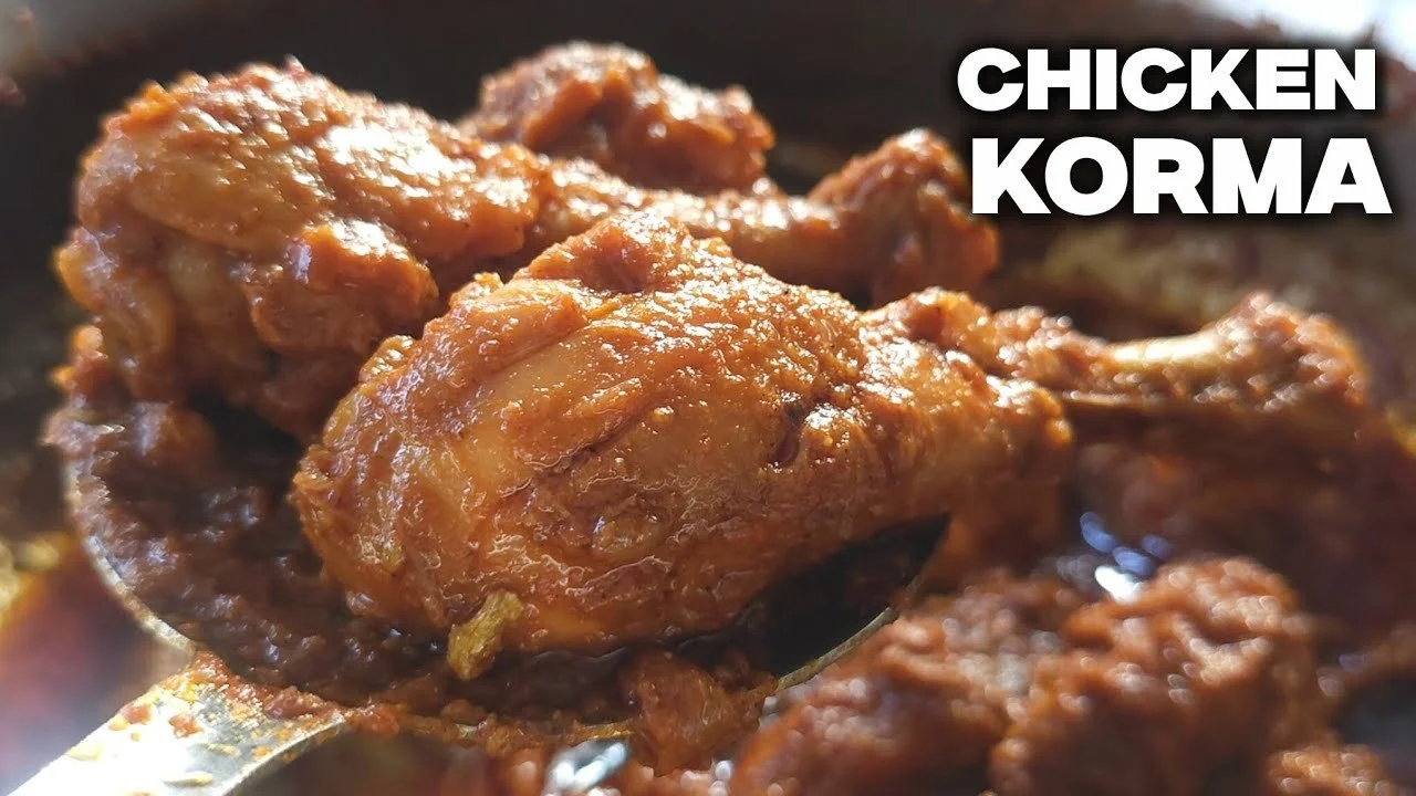 Delicious Chicken Korma served with rice and naan, showcasing rich spices and creamy sauce.