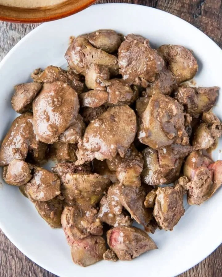 Deliciously cooked chicken liver fry served on a plate with herbs.