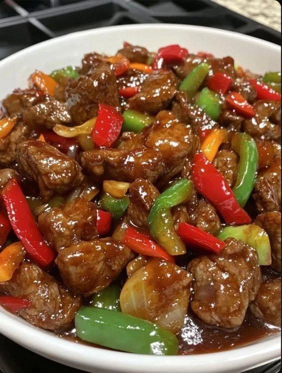 Delicious Chinese onion pepper steak served with vibrant vegetables and rice