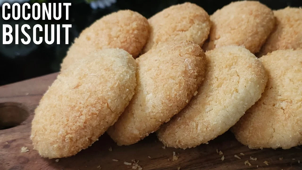 Crispy Coconut Biscuits arranged on a plate, showcasing their golden-brown texture.