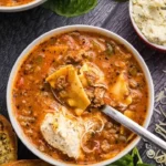 Bowl of delicious Crockpot Lasagna Soup garnished with fresh herbs