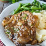 Delicious cube steak with onion gravy served on a plate