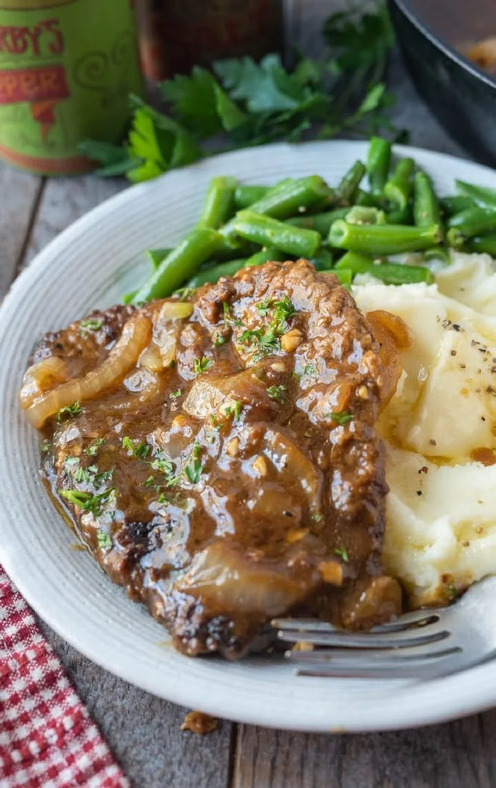 Delicious cube steak with onion gravy served on a plate