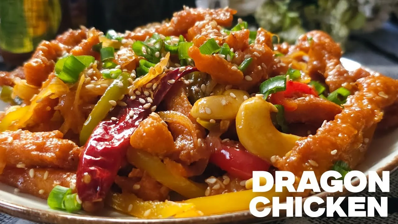 Plate of spicy Dragon Chicken served with colorful vegetables and rice