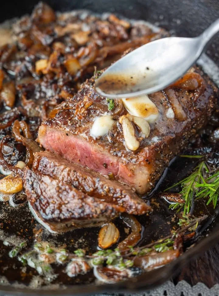 Grilled Garlic Rib Eye Steak with herbs and spices on a plate