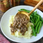 Bowl of ground beef and gravy served with mashed potatoes