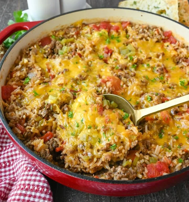 Ground beef and rice skillet cooked with vegetables in a frying pan