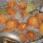 A plate of Gulgule, traditional Indian sweet made from flour and jaggery.