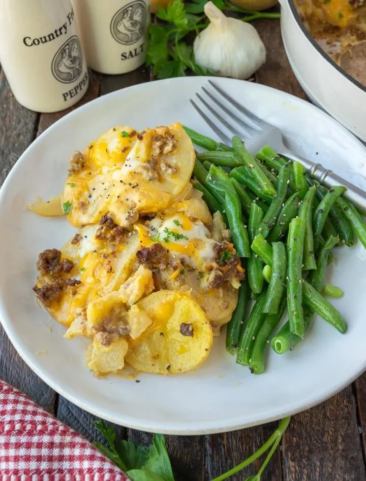Delicious Hamburger Potato Casserole served with cheese and herbs.