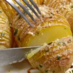 Deliciously crispy Hasselback Potatoes garnished with herbs