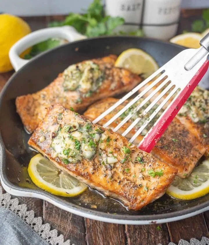 Herb Grilled Salmon Herb grilled salmon garnished with fresh herbs and served on a plate