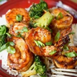 Delicious Honey Garlic Butter Shrimp served in a skillet with fresh herbs.