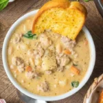 Bowl of Italian Sausage White Bean Soup garnished with herbs