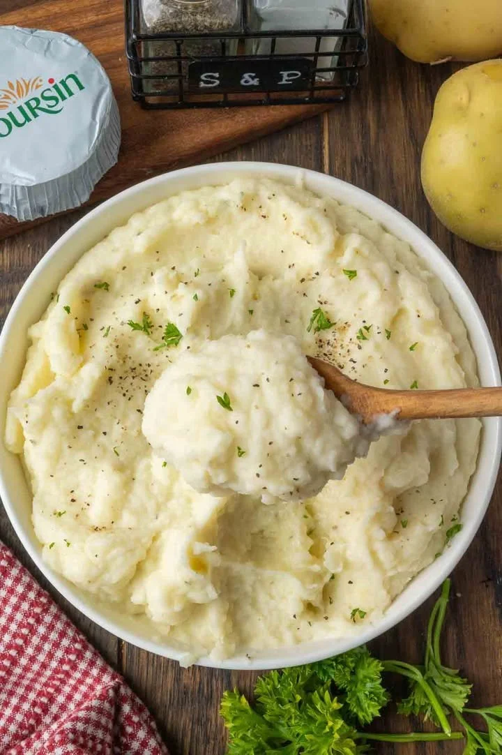 Creamy mashed potatoes with Boursin cheese in a bowl