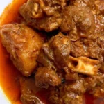 Delicious mutton curry with potatoes served in a traditional dish.