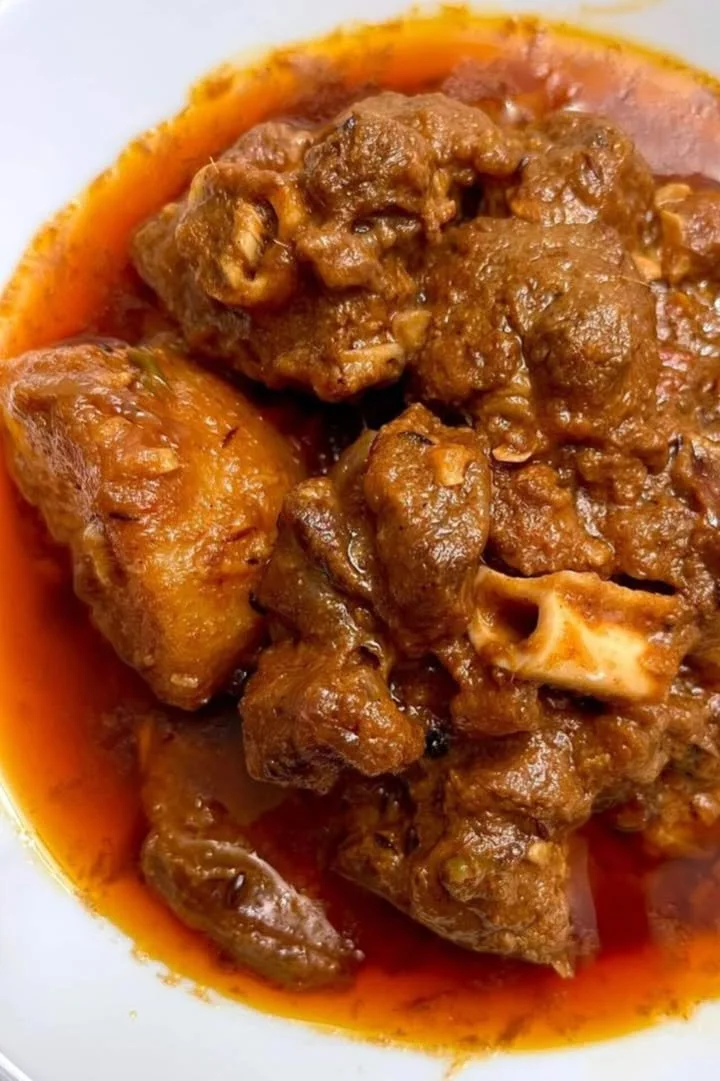 Delicious mutton curry with potatoes served in a traditional dish.