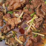 home Delicious mutton karahi served in a traditional pan with spices and garnish