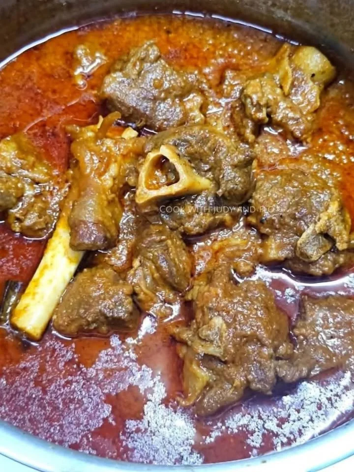 Delicious Mutton Korma served with rice and garnished with fresh herbs