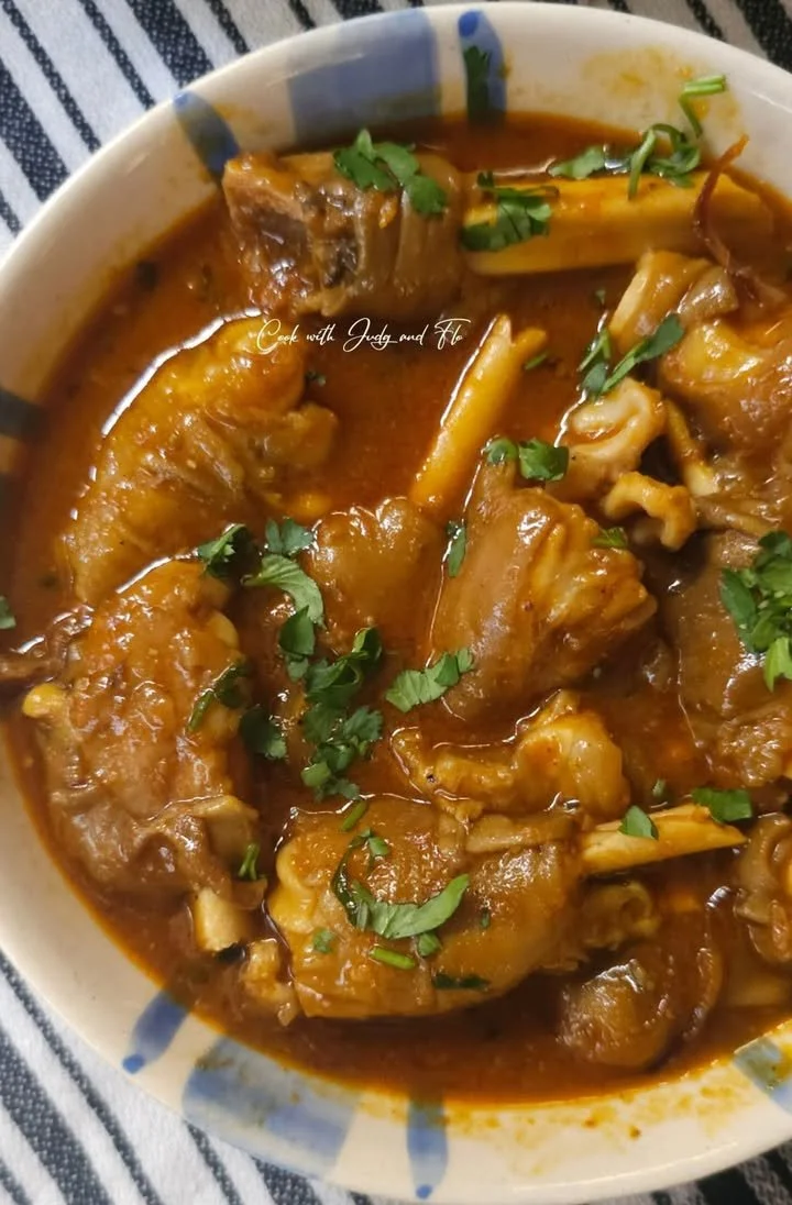 Delicious bowl of Mutton Leg Curry garnished with fresh herbs