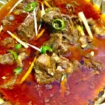 Delicious Mutton Nihari served in a traditional dish with spices and herbs.