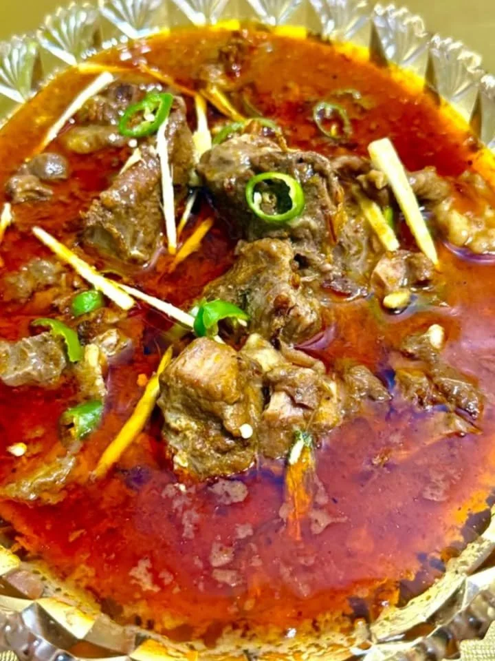 Delicious Mutton Nihari served in a traditional dish with spices and herbs.