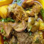 home Delicious plate of simple chicken curry cooked with spices and served with rice.