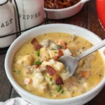 home Delicious slow cooker cheeseburger soup garnished with cheese and herbs.
