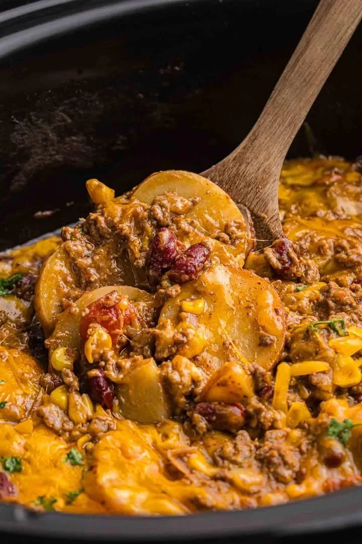 Slow Cooker Cowboy Casserole Delicious Slow Cooker Cowboy Casserole in a ceramic dish with toppings