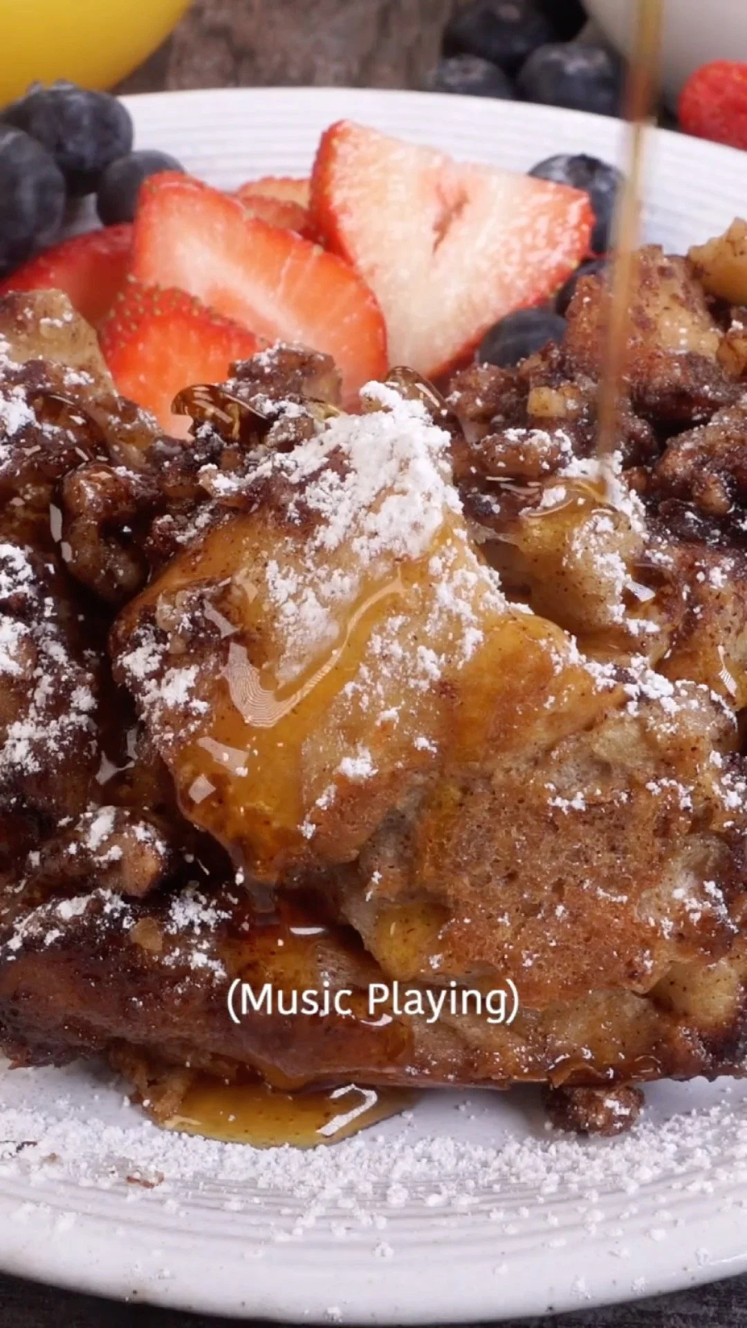Deliciously baked Slow Cooker French Toast Casserole topped with syrup and fruit