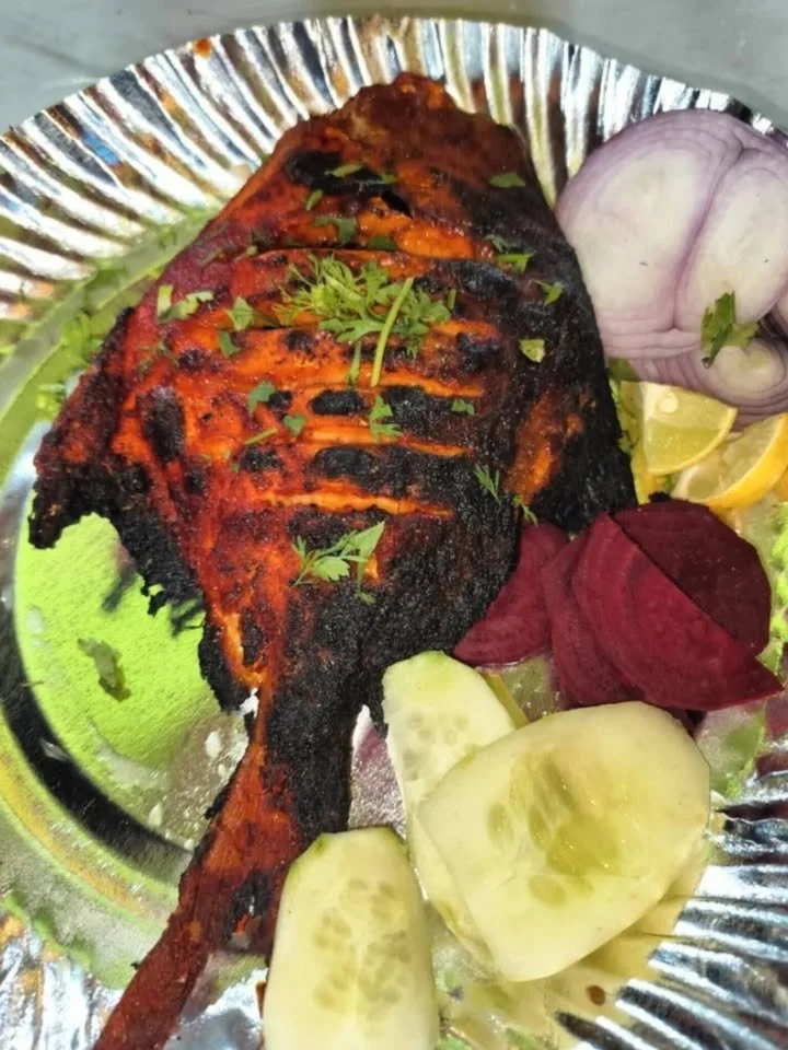 Delicious Tandoori Pomfret ready to serve in a restaurant-style presentation.