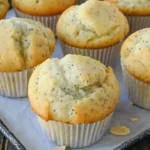 Freshly baked almond poppy seed muffins on a cooling rack