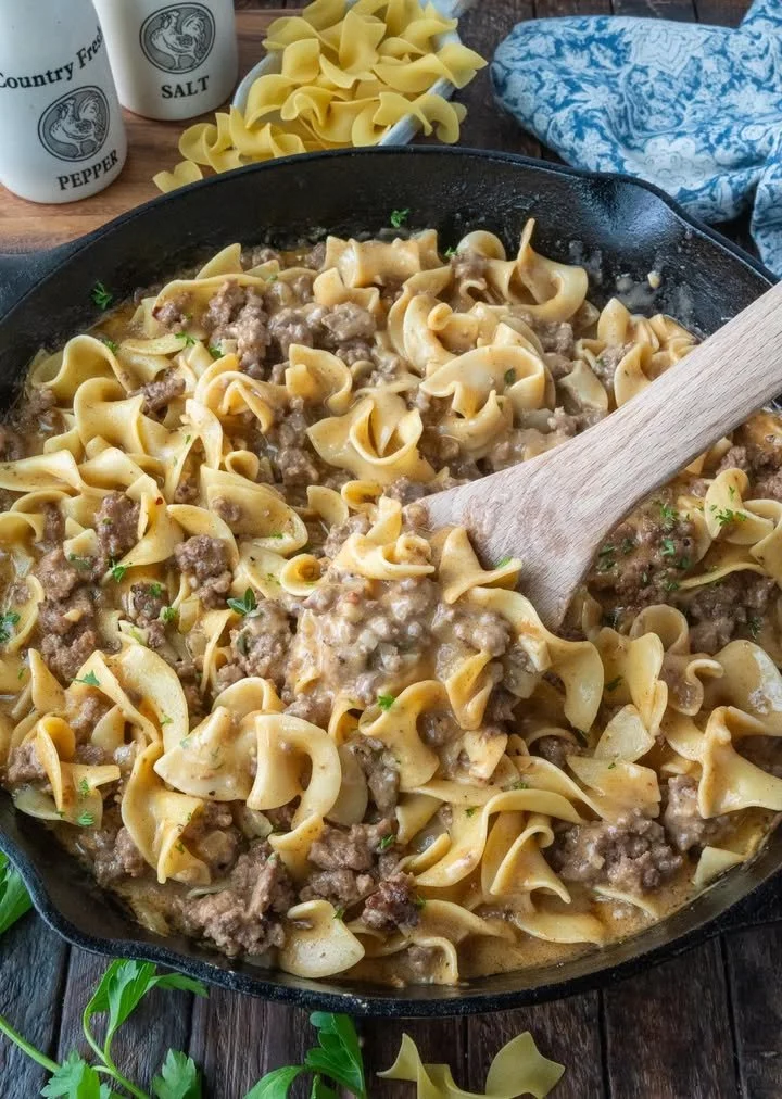 A delicious plate of beef and noodles garnished with herbs