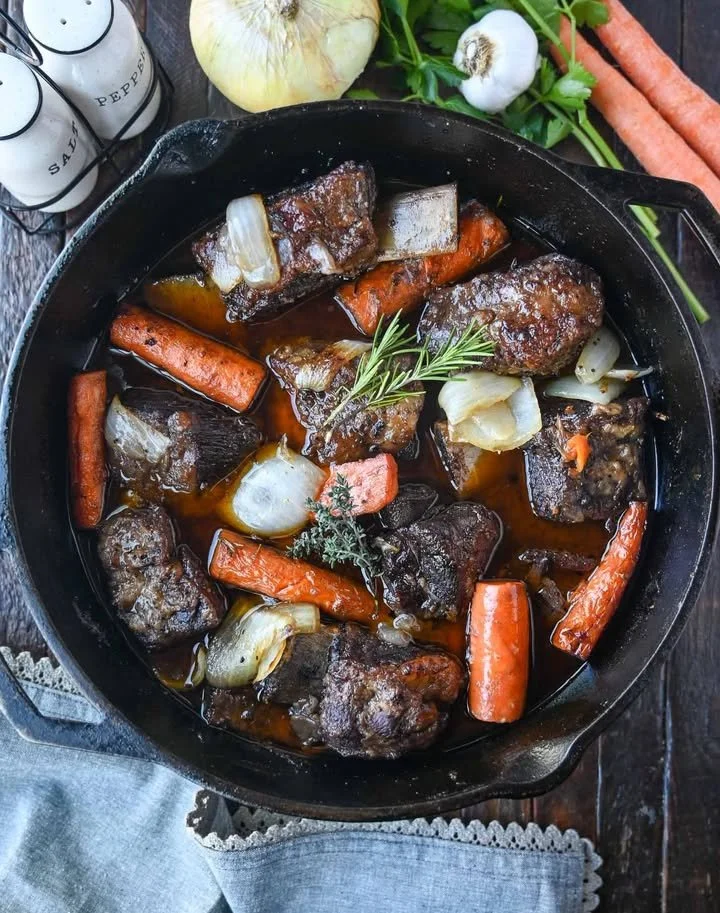 Delicious braised short ribs served with vegetables and sauce