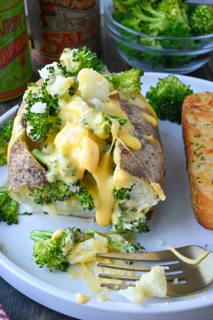 Broccoli Cheese Baked Potato Delicious broccoli cheese baked potato topped with melted cheese and broccoli florets.