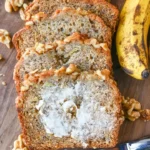 Slice of homemade copycat Starbucks banana bread on a wooden cutting board