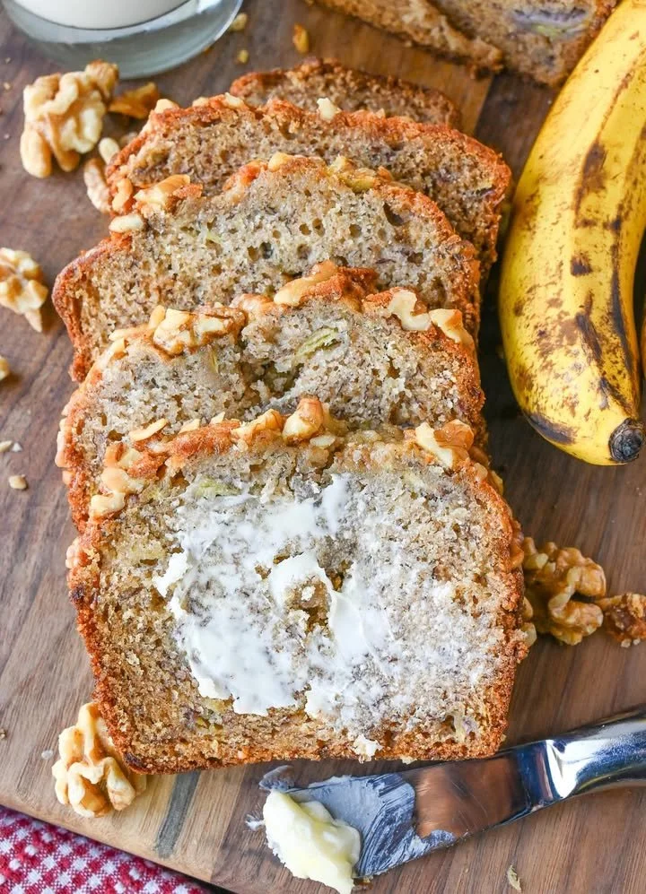 Slice of homemade copycat Starbucks banana bread on a wooden cutting board