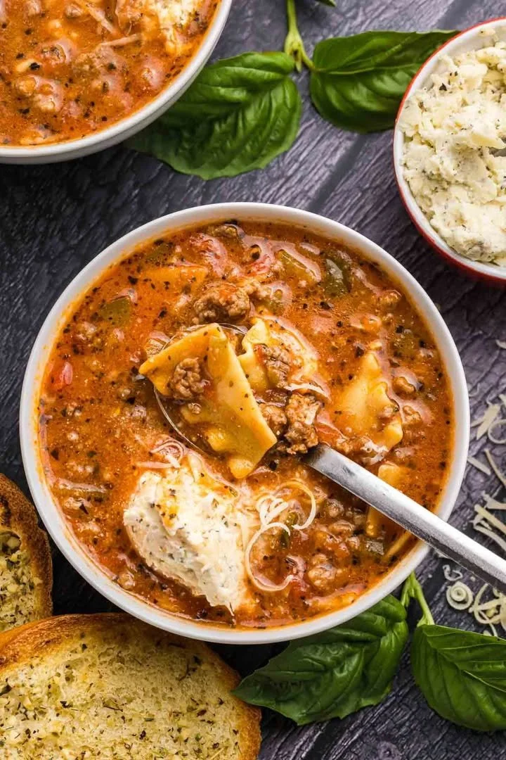 Bowl of Crockpot Lasagna Soup garnished with herbs