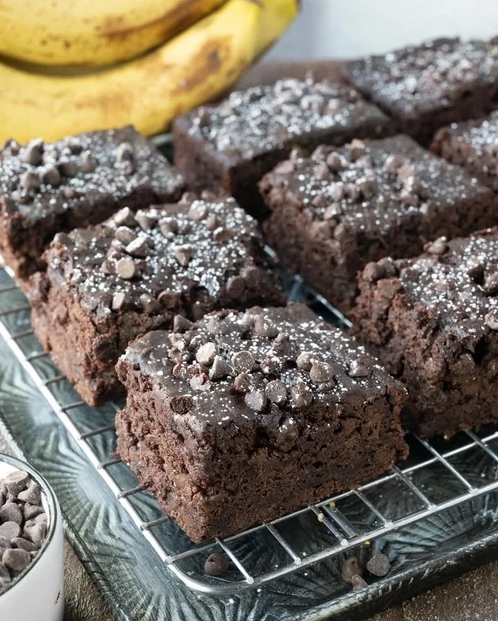 Double chocolate banana cake topped with chocolate frosting and banana slices