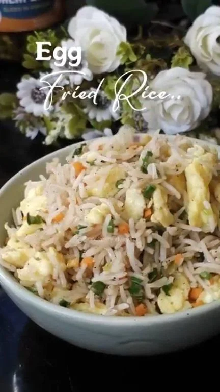 Delicious Egg Fried Rice served in a bowl with vegetables and spices
