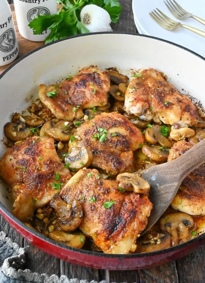 Plate of garlic mushroom chicken with herbs and spices