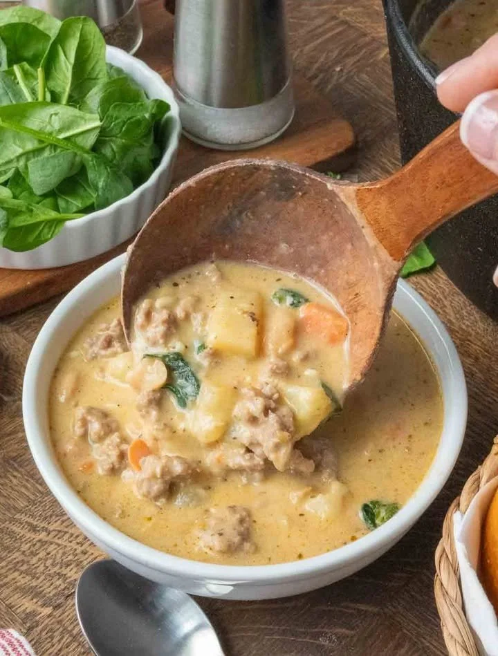 Italian Sausage White Bean Soup Bowl of Italian Sausage White Bean Soup garnished with herbs.