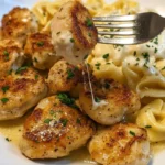 home Lemon Garlic Butter Chicken Bites served with creamy tortellini in a bowl