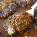 Homemade Salisbury Steak served with gravy and mashed potatoes