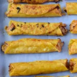 Delicious slow cooker chicken taquitos garnished with fresh toppings