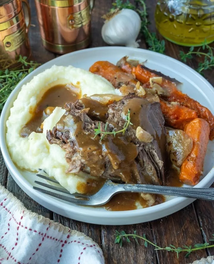 Slow-cooked classic pot roast with vegetables in a serving dish