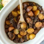 home Delicious Slow Cooker Garlic Butter Steak Bites served with tender potatoes